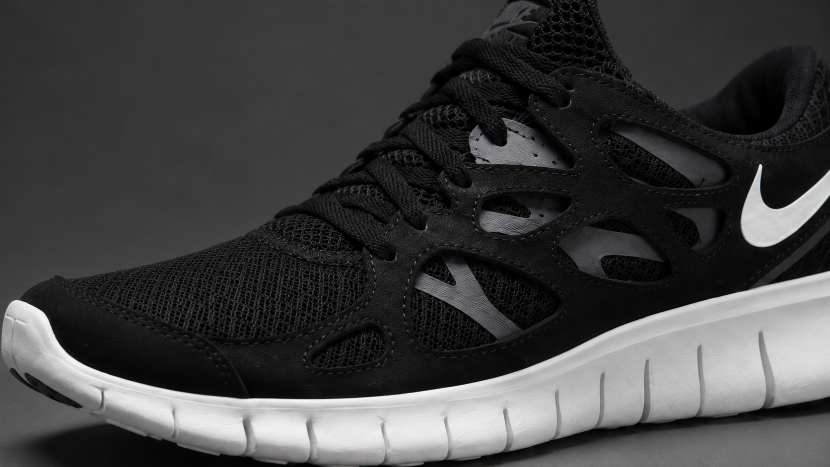 Крупный план конструкции верха и сегментированной подошвы Nike Free Run 2